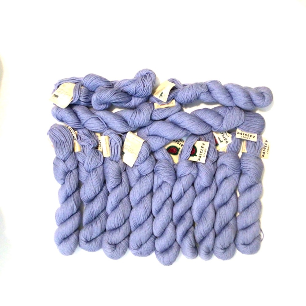 13 skeins of Classic Elite periwinkle wool and viscose (rayon) yarn.